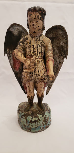 Wood carved angel with tin wings