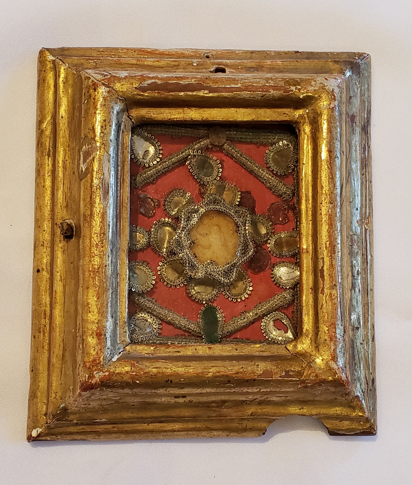 Small reliquary on golden frame