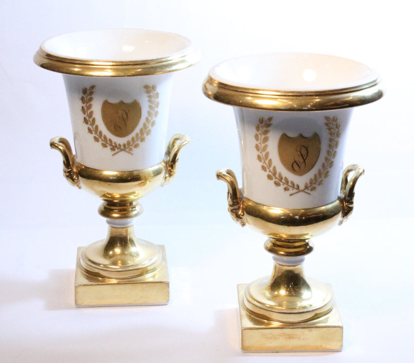 Set of two white and gold porcelain urn vases